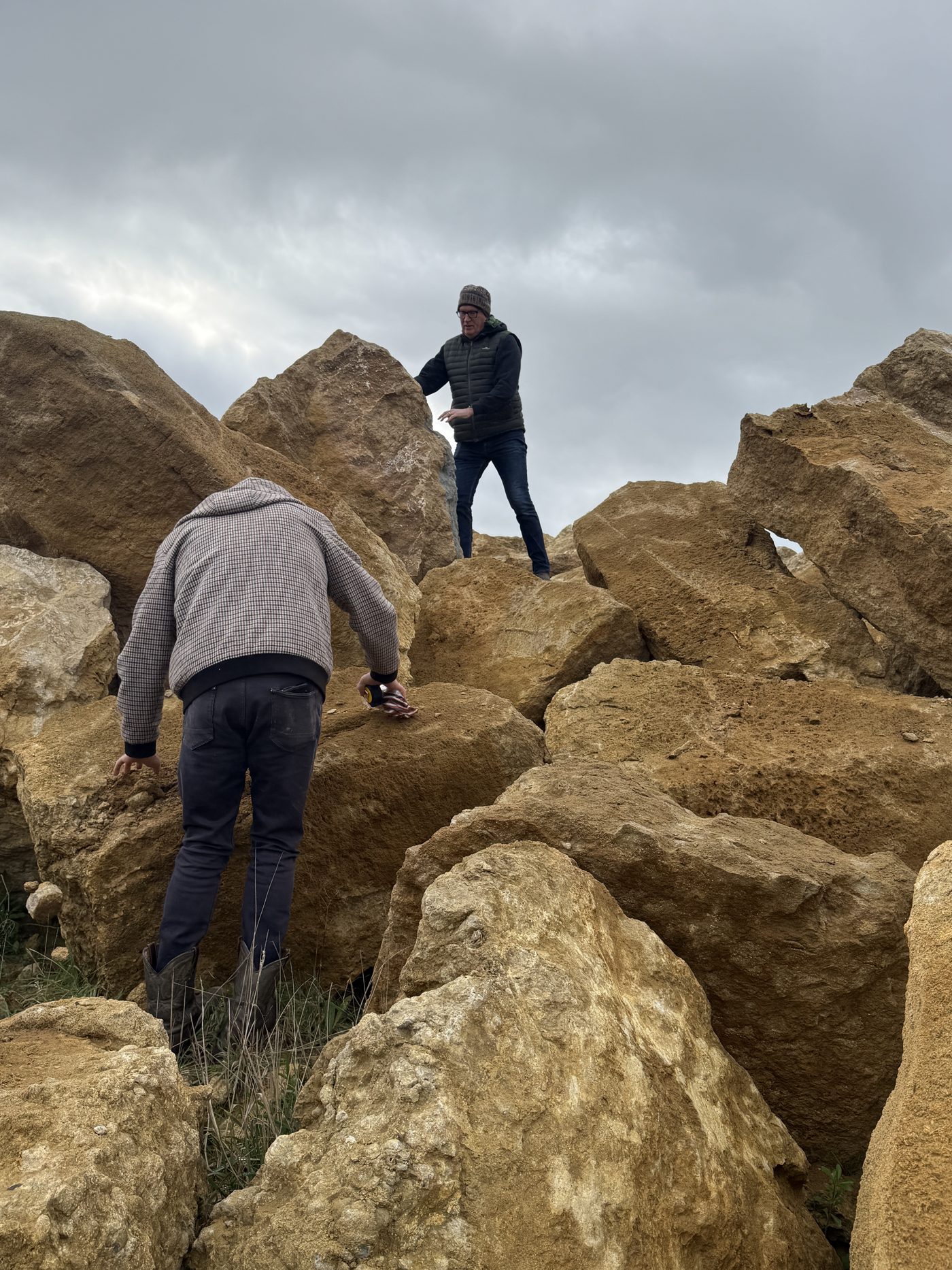Hand-picking limestone boulders at the quarry before construction