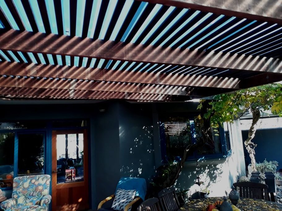 Homestead Garden. Poraiti, The 2002 pergola: hardwood beams, clear roofing, lived under all summer